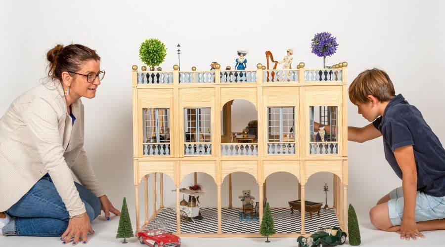 une-maman-et-son-enfant-jouant-au-maison-de-poupee-en-bois.jpg
